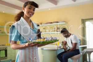 Waitress holding a tray of breakfast