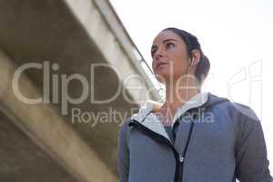 Thoughtful female jogger listening to music