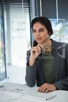 Thoughtful female executive sitting at desk