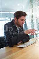 Businessman gesturing at desk