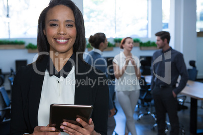 Female executive using digital tablet in office Female executive using digital tablet in office