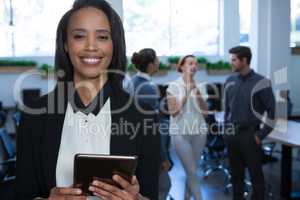 Female executive using digital tablet in office