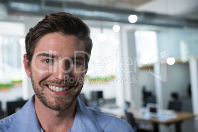 Male executive looking at camera in the office