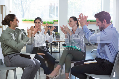 Group of executives applauding in the office