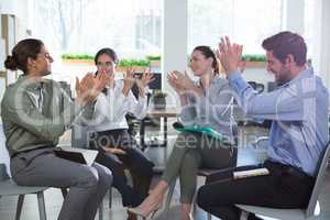 Group of executives applauding in the office