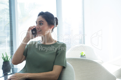 Female executive talking on mobile phone in the office