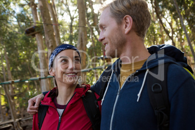Hiker couple standing in forest