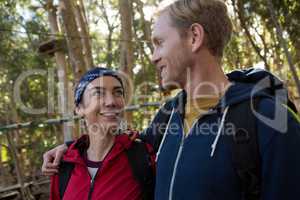 Hiker couple standing in forest