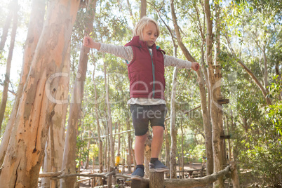 Little girl walking on woods