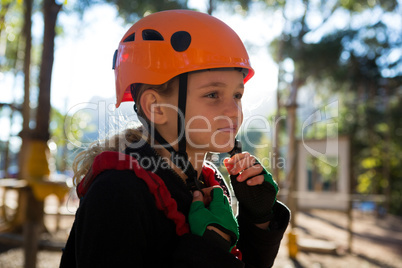 Little girl removing her safety helmet on a sunny day