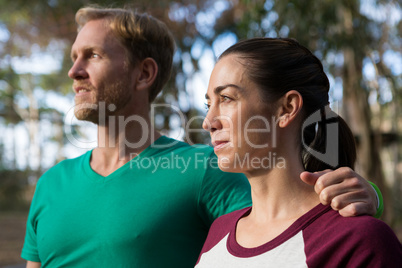 Woman and trainer looking away