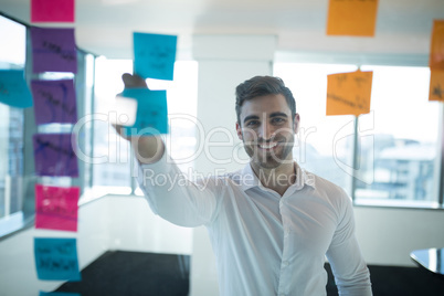 Male executive reading sticky note