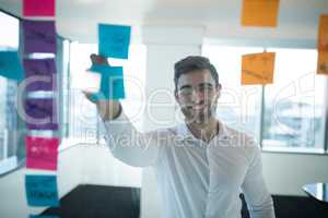 Male executive reading sticky note