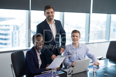 Portrait of executives sitting at desk