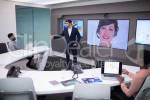 Male and female executives having video call