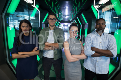 Portrait of business executives standing with arms crossed