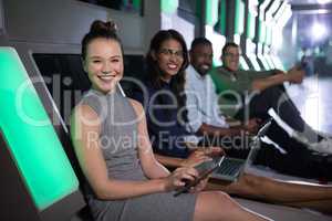 Portrait of business executives sitting with laptop and digital tablet