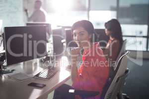 Female executive sitting at desk in office