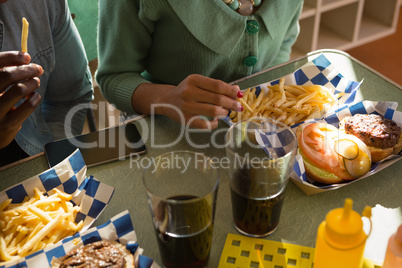Couple hands having fast food in the restaurant