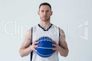 Basketball player holding ball against white background