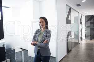 Confident businesswoman standing in corridor