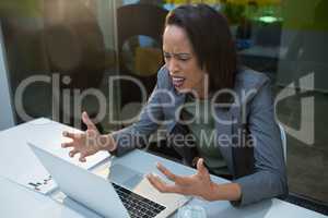 Irritated woman working at desk