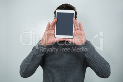 Executive hiding his face with digital tablet
