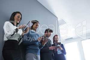 Team of business people using electronic devices