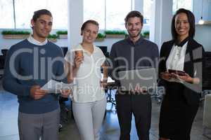 Business colleagues standing together in office