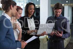 Business colleagues discussing over laptop