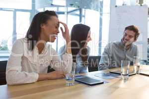 Business colleagues interacting with each other in conference room