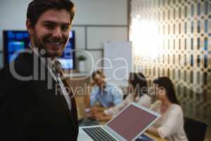 Businessman using laptop in conference room