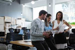 Executives discussing over laptop