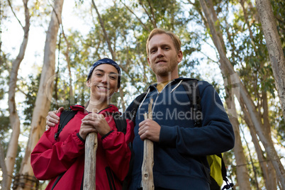 Portrait of hiker couple standing in forest