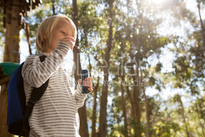 Little girl blowing bubbles on a sunny day