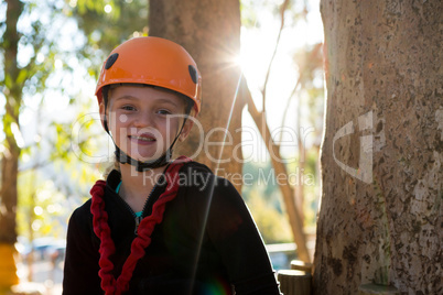 Portrait of beautiful little girl wearing helmet in the forest