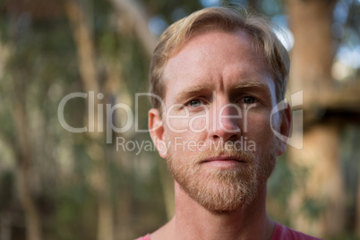 Man face covered with bright sun light in forest