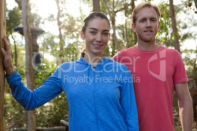 Man and woman trainer standing together in forest