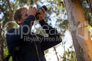 Man using dslr camera in the forest