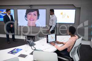 Male and female executives having video call