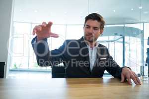 Businessman gesturing at desk