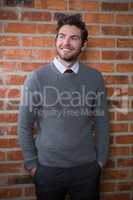 Smiling executive standing with hands in pocket