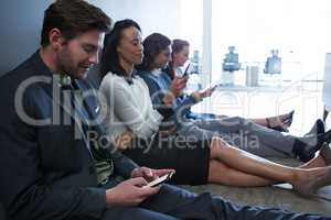 Team of business people using mobile phone