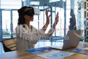 Female executive using virtual reality headset