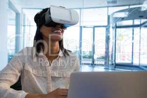 Female executive using virtual reality headset