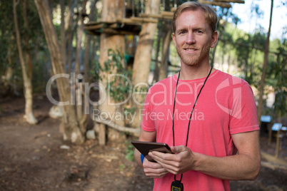 Trainer using his tablet on a sunny day