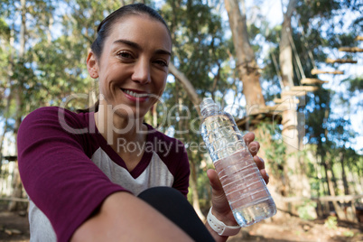 Woman holding water bottle in her hand