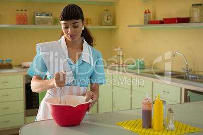 Waitress preparing food in restaurant