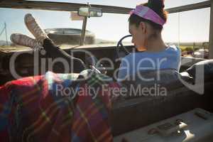 Woman using mobile phone in car