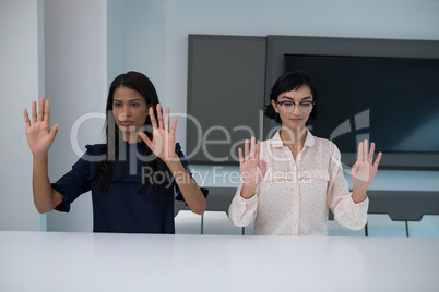 Business executives gesturing in boardroom